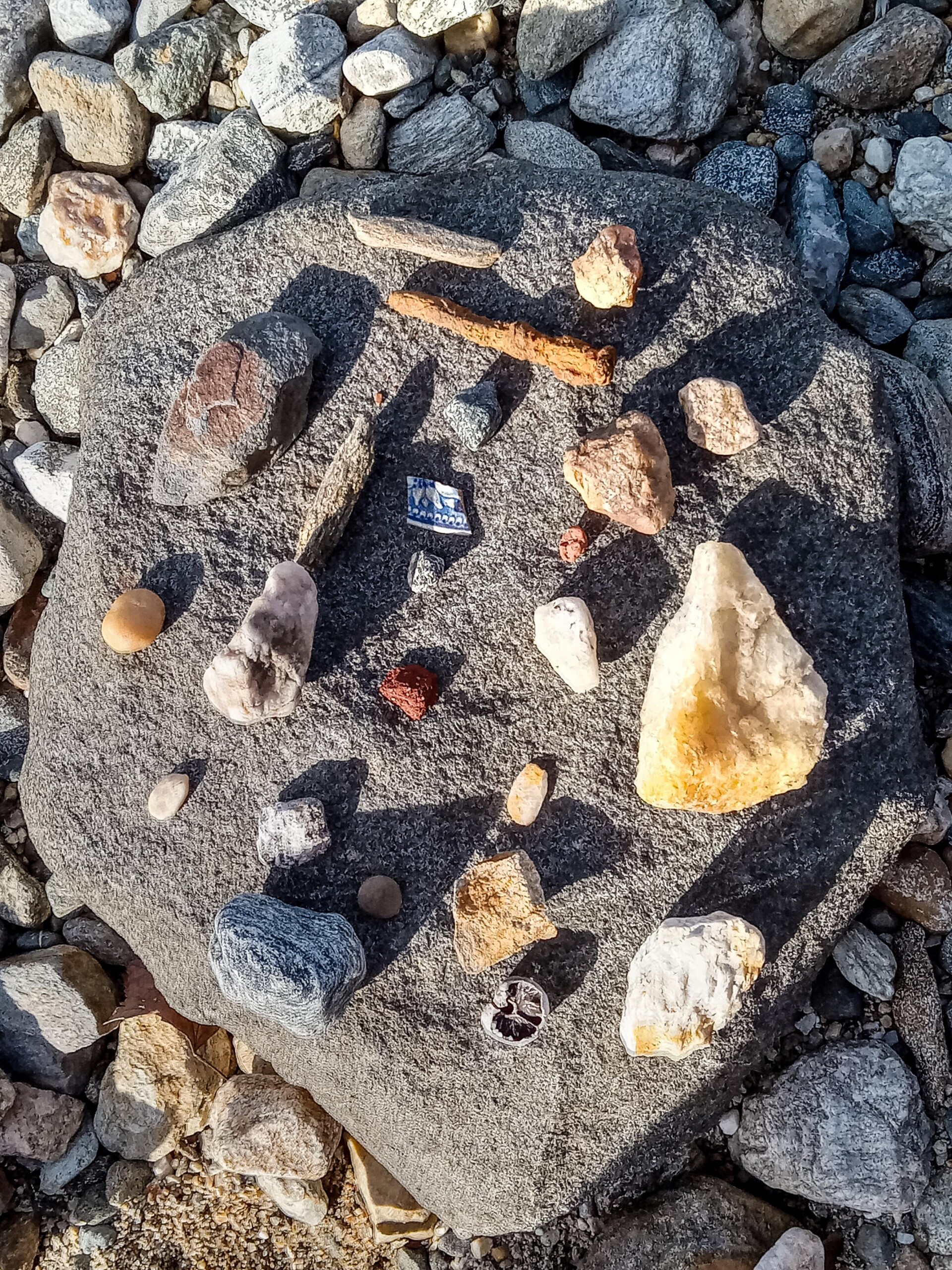 color photograph of carefully arranged small stones and detritus on a flat rock